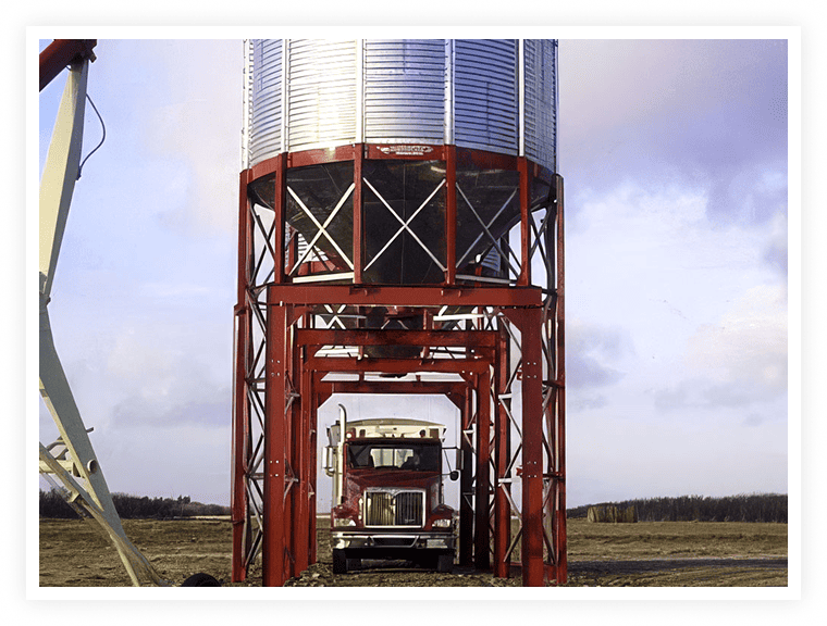 Drive-under hopper bin for fast grain truck loading