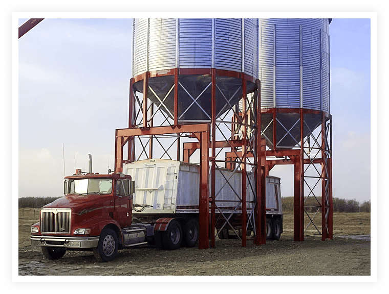 Drive-under grain hopper with truck loading